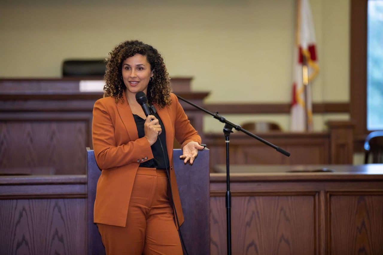 Christine Sylvain speaking at courtroom podium